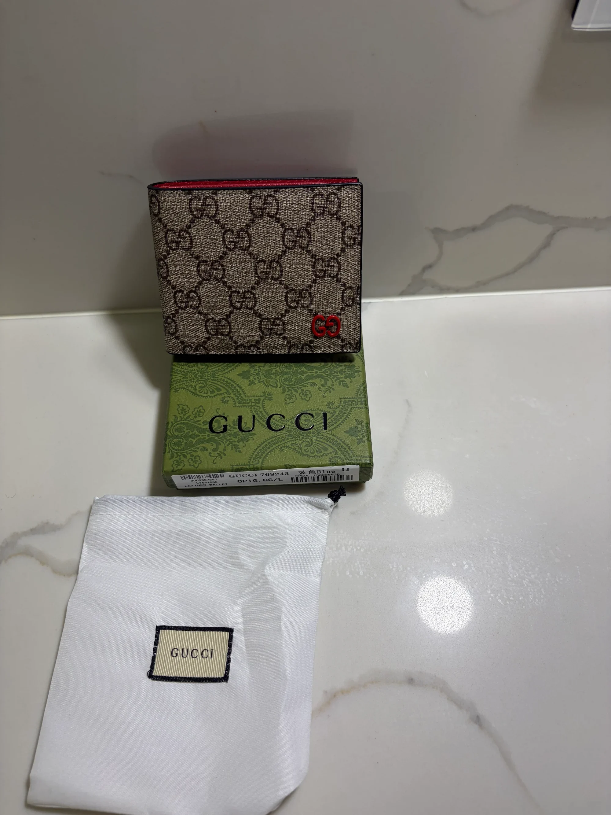 Gucci GG Supreme wallet features a distinct red leather interior and red interlocking G hardware